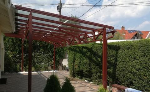 Porfestett acél tartószerkezet rácsostartóval + ragasztott biztonsági üveg fedéssel készült autóbeálló